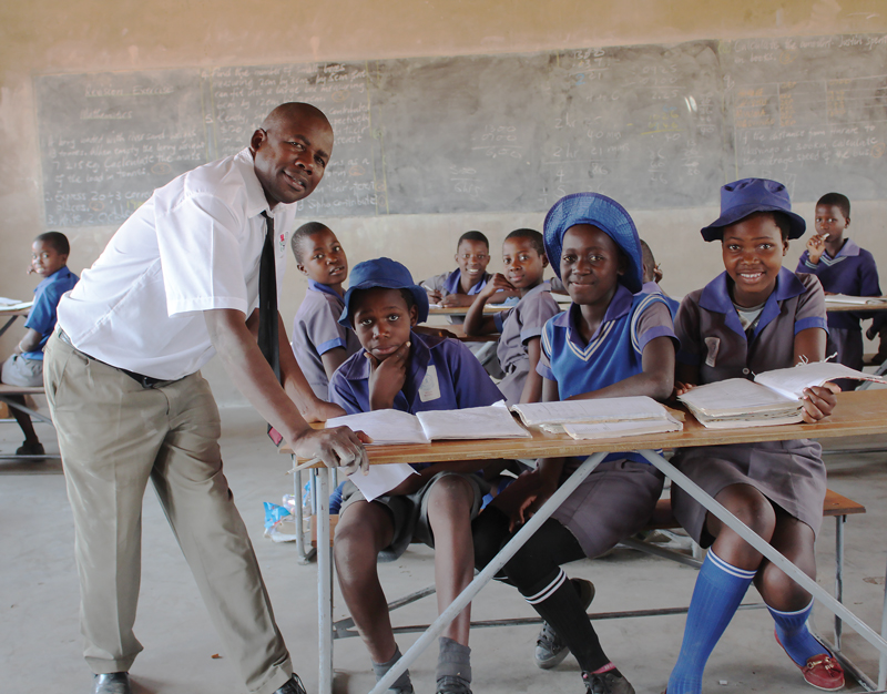 The headmaster with students at Seula Primary School in Zimbabwe