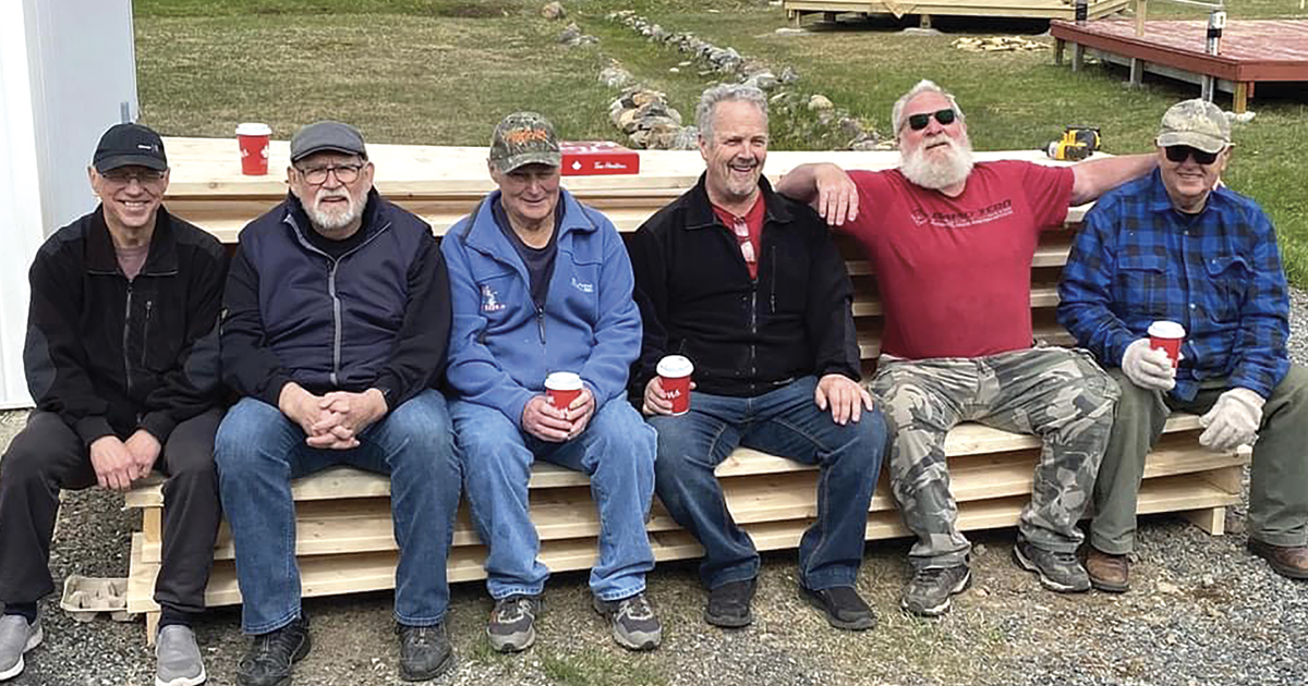 Volunteers rest while building a gazebo at the park